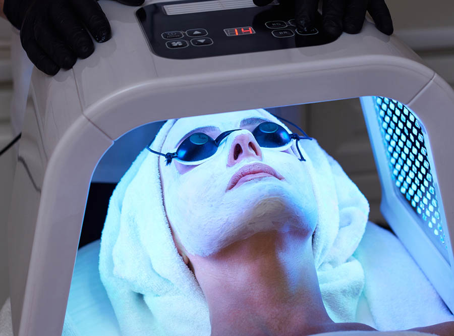 Woman Getting Facial Treatment With Led Therapy